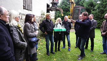 Der Oberbauleiter mit Beteiligten auf dem Baugrundstück